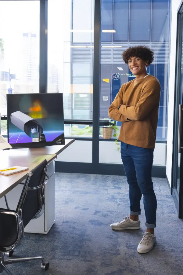 smiling-young-man-standing-confidently-in-modern-o-2025-04-03-11-52-37-utc-1